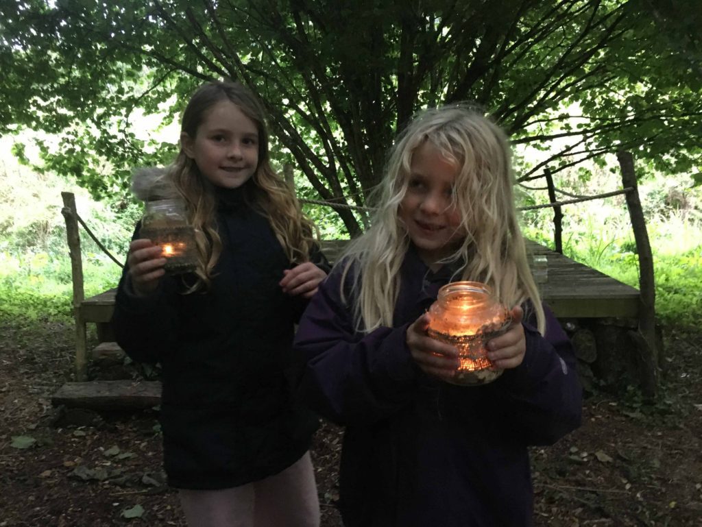 Recent campers with tealights at Wilton Farm campsite wooded Glade
